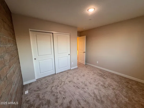 a view of an empty room and closet area