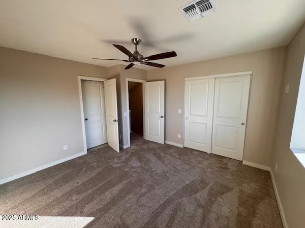 a view of empty room with ceiling fan