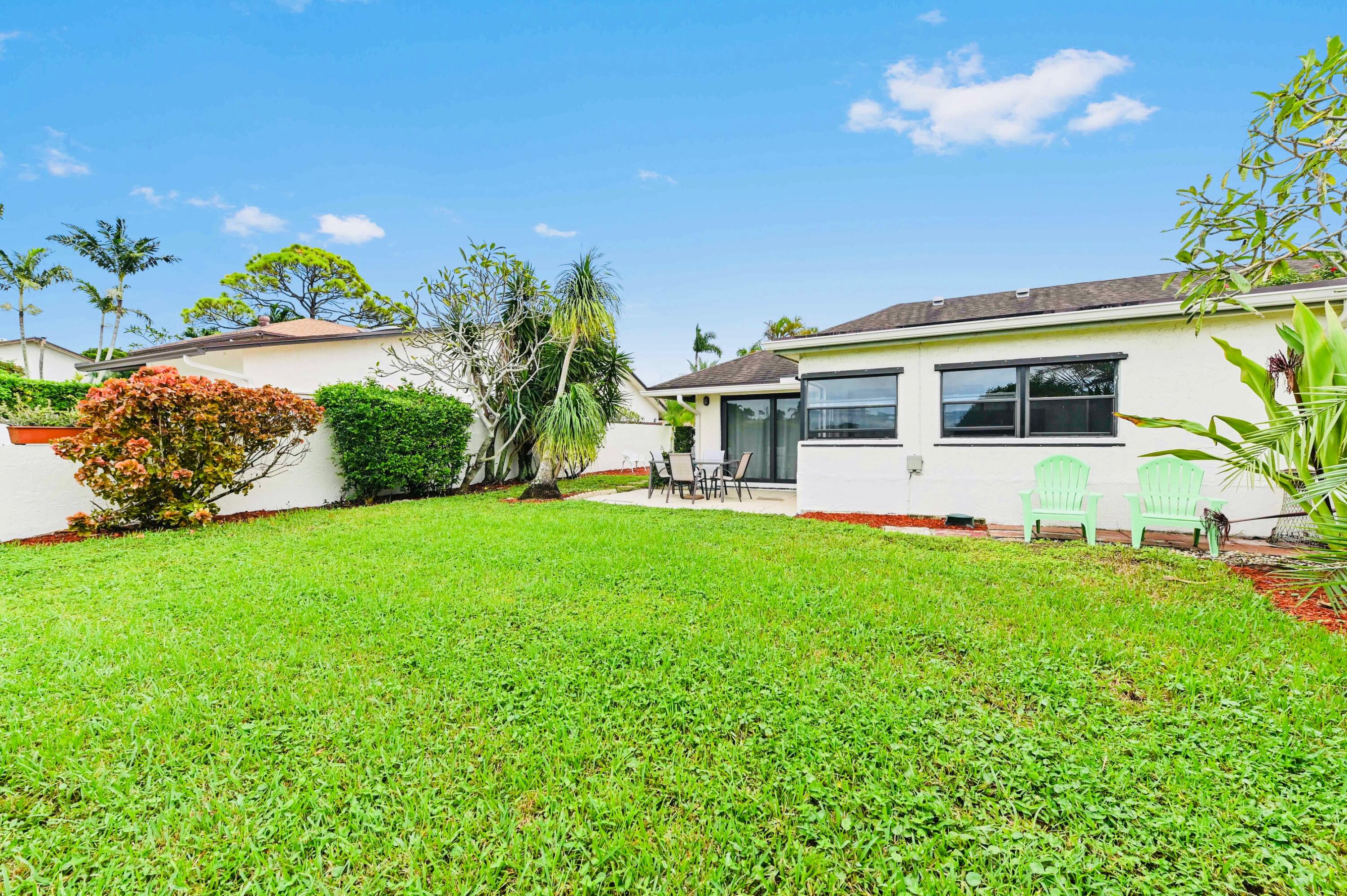 2749 Southwest 5th Street Delray Beach, FL 33445 - Photo 12 of 55 a view of a house with a yard and potted plants
