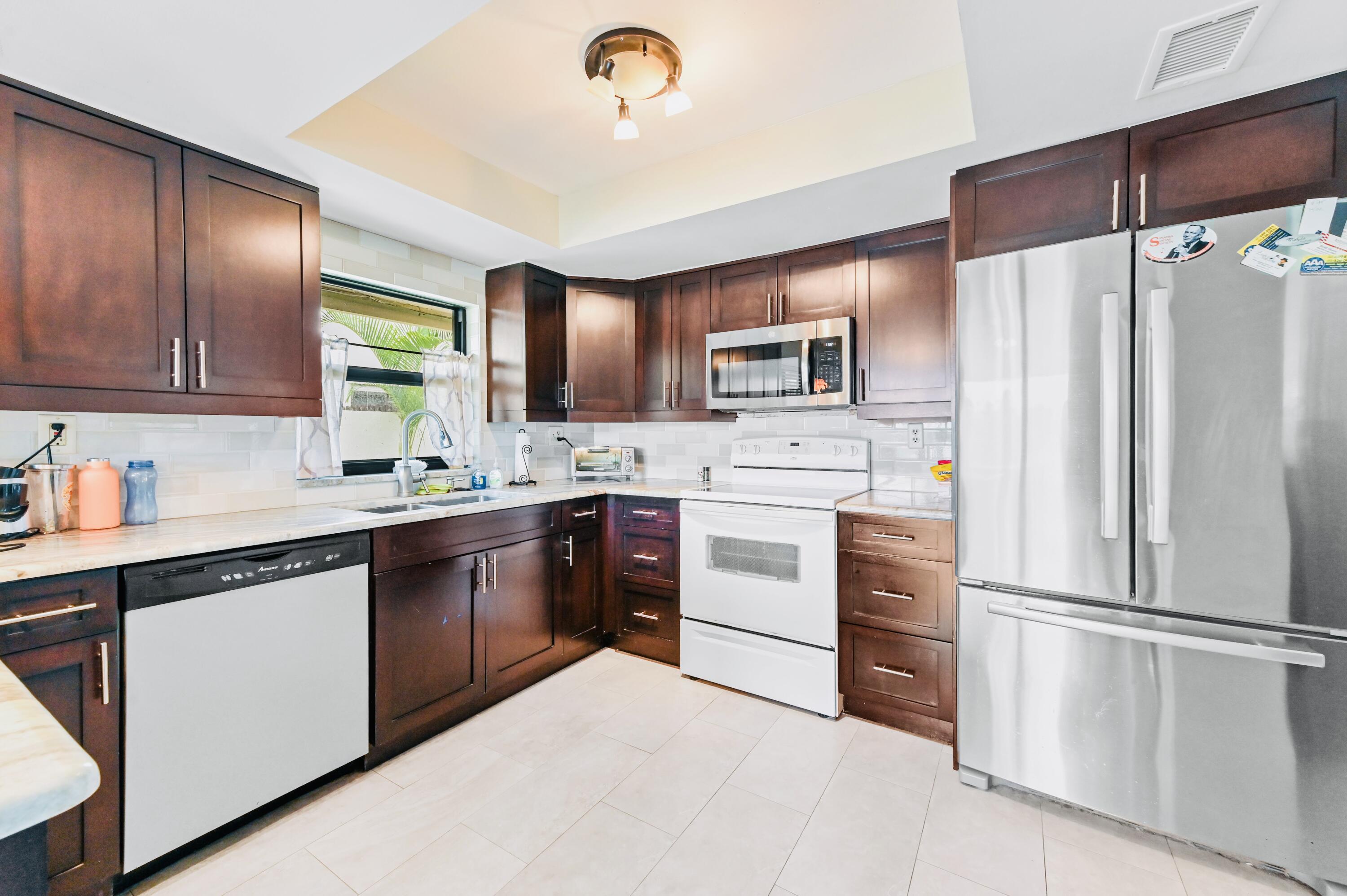 2749 Southwest 5th Street Delray Beach, FL 33445 - Photo 22 of 55 a kitchen with a refrigerator stove and sink