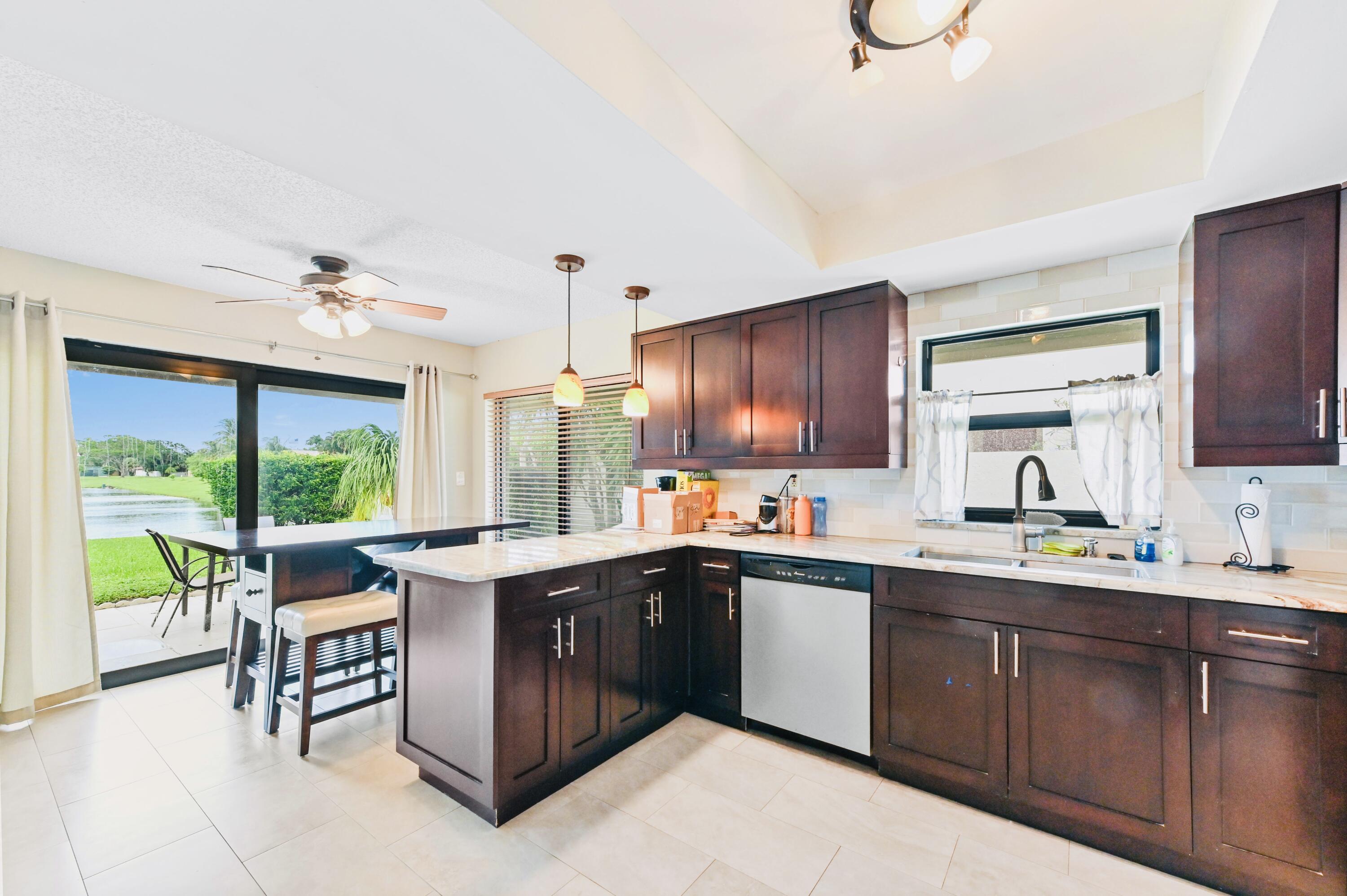 2749 Southwest 5th Street Delray Beach, FL 33445 - Photo 23 of 55 a kitchen with a sink and wooden cabinets