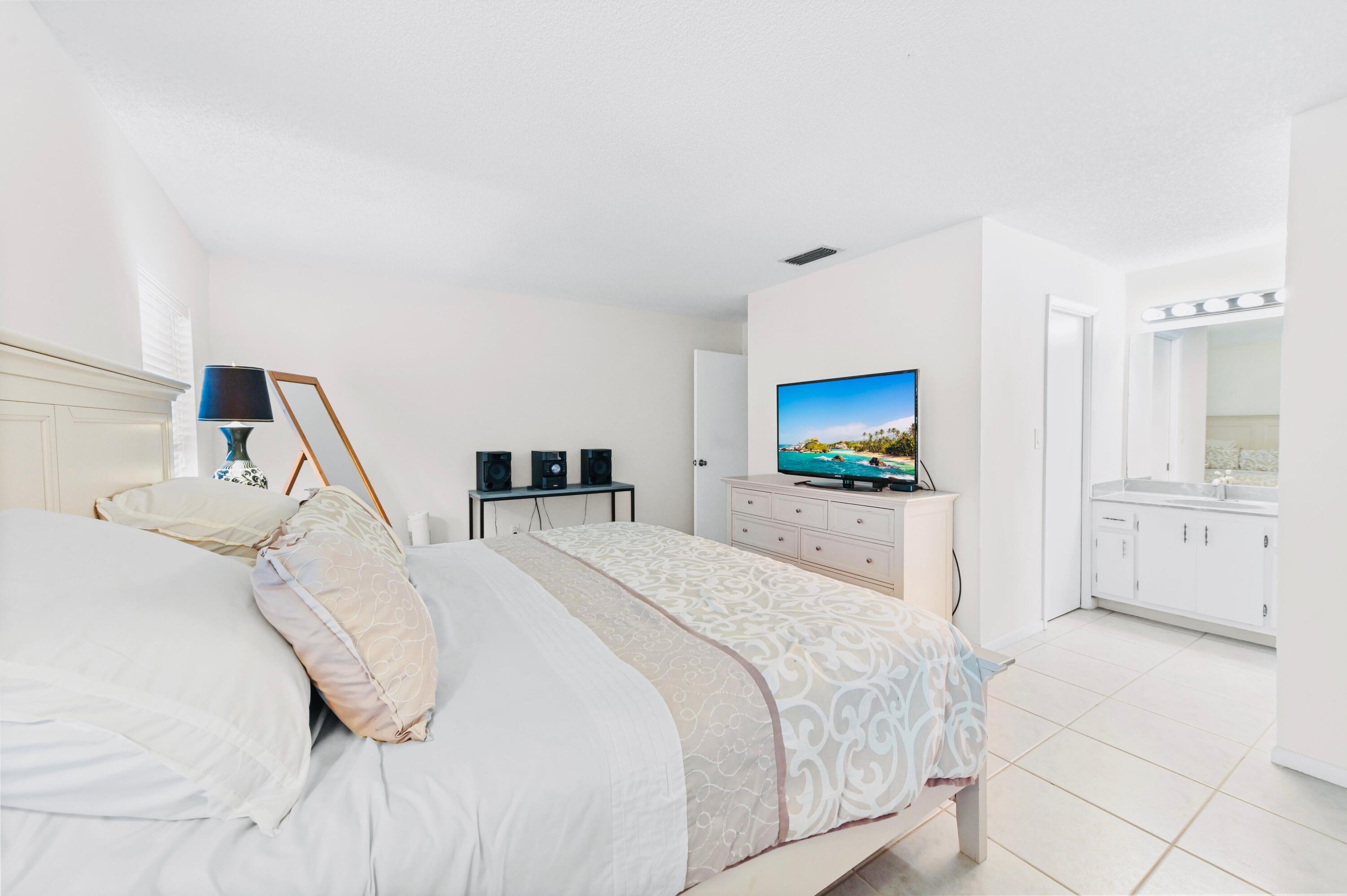 2749 Southwest 5th Street Delray Beach, FL 33445 - Photo 30 of 55 a bedroom with a bed and a flat screen tv