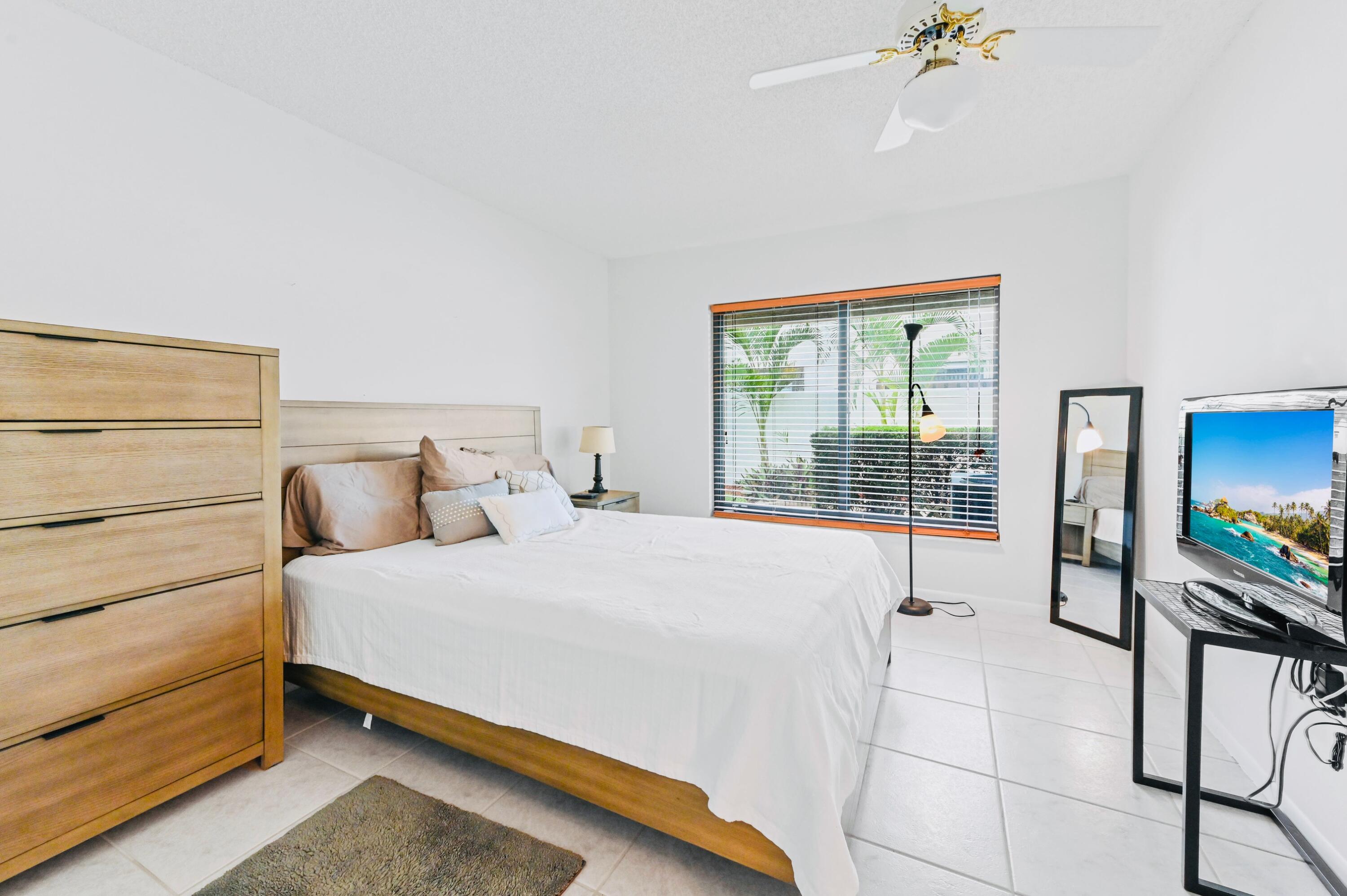 2749 Southwest 5th Street Delray Beach, FL 33445 - Photo 31 of 55 a bedroom with a bed and a chandelier