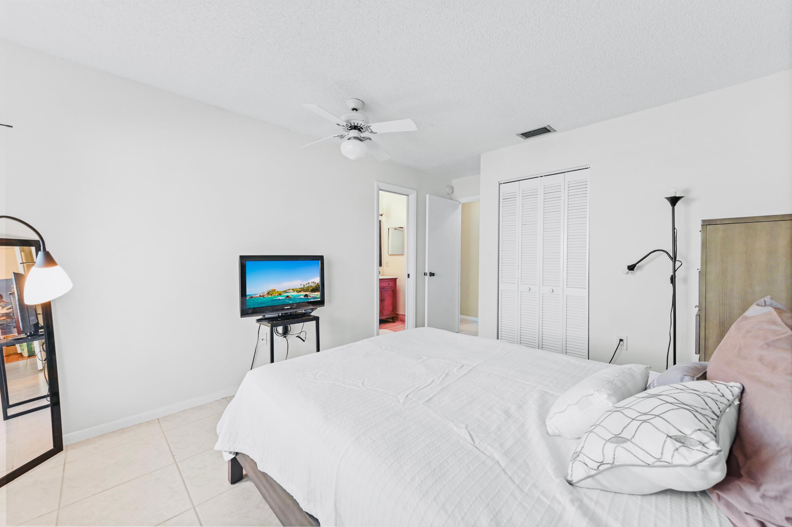 2749 Southwest 5th Street Delray Beach, FL 33445 - Photo 32 of 55 a bedroom with a bed and a flat screen tv