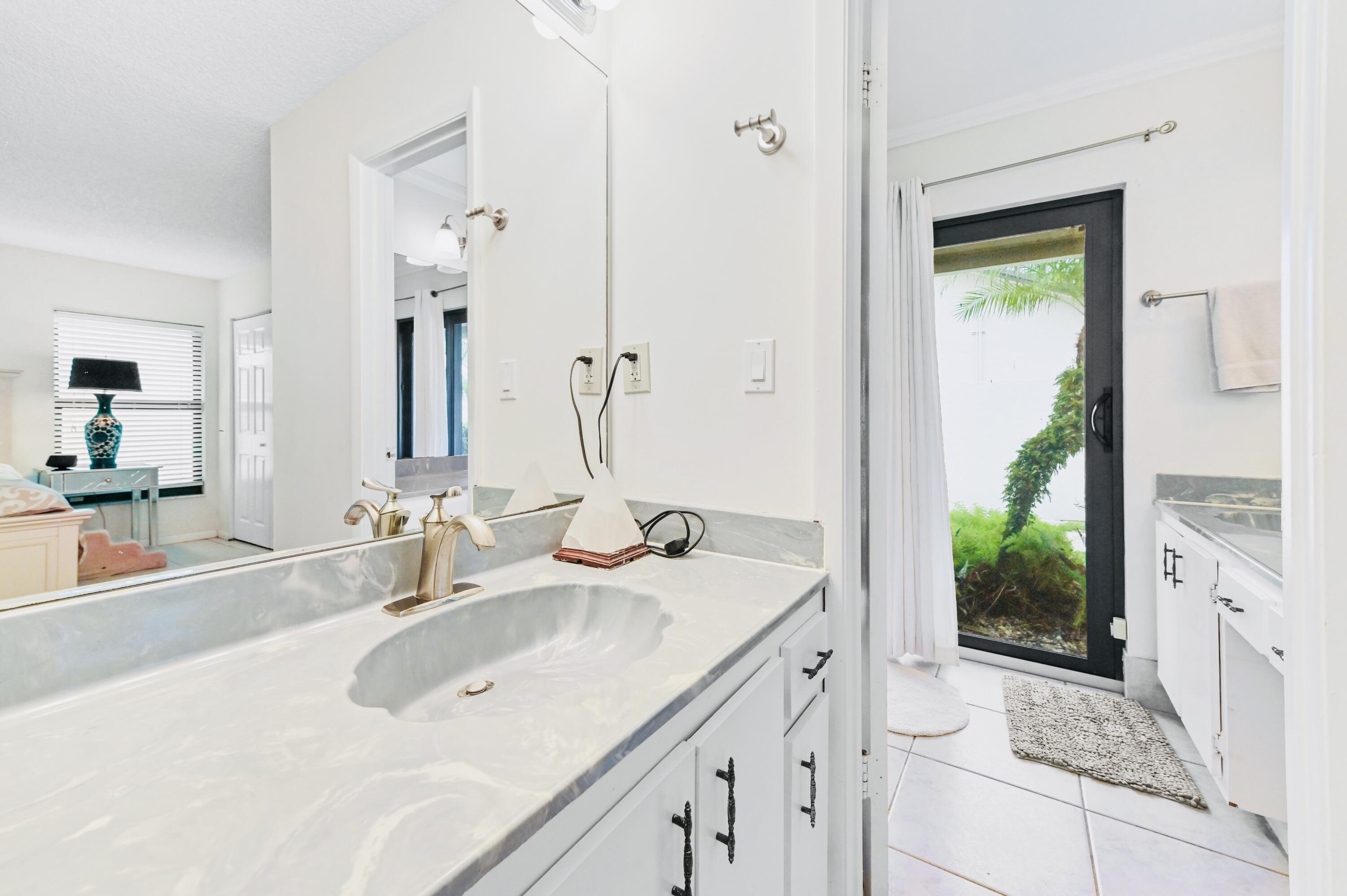 2749 Southwest 5th Street Delray Beach, FL 33445 - Photo 35 of 55 a bathroom with a sink and a mirror
