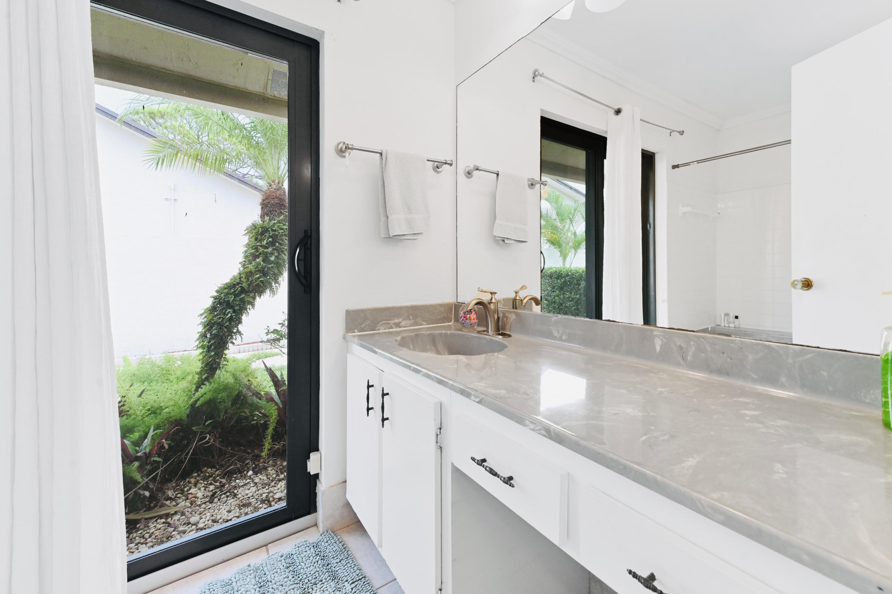 2749 Southwest 5th Street Delray Beach, FL 33445 - Photo 36 of 55 a bathroom with a granite countertop sink and a mirror