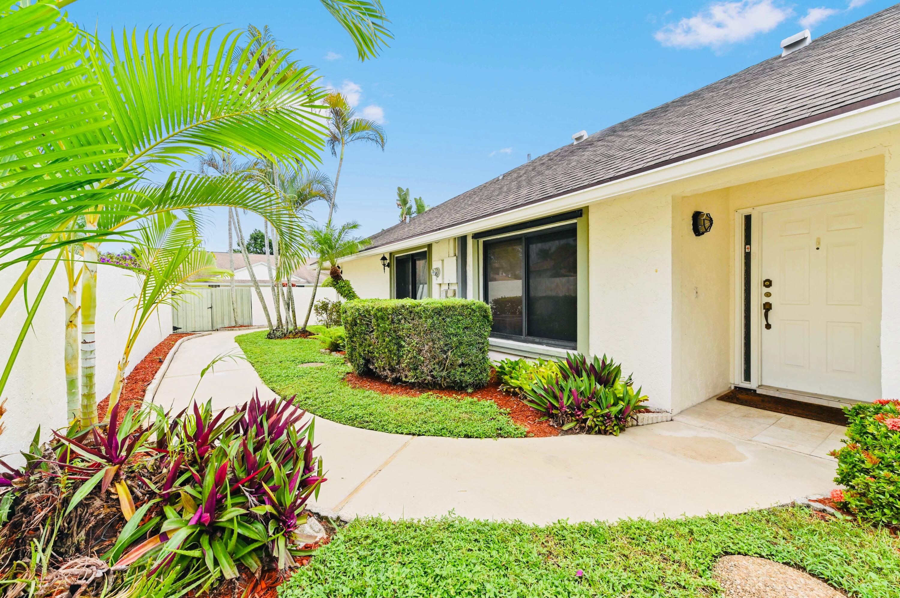 2749 Southwest 5th Street Delray Beach, FL 33445 - Photo 6 of 55 a front view of a house with garden