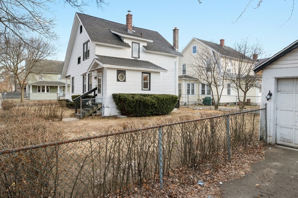 126 Stockman Street Springfield, MA 01104 - Photo 23 of 25 a view of a white house next to a yard with large trees