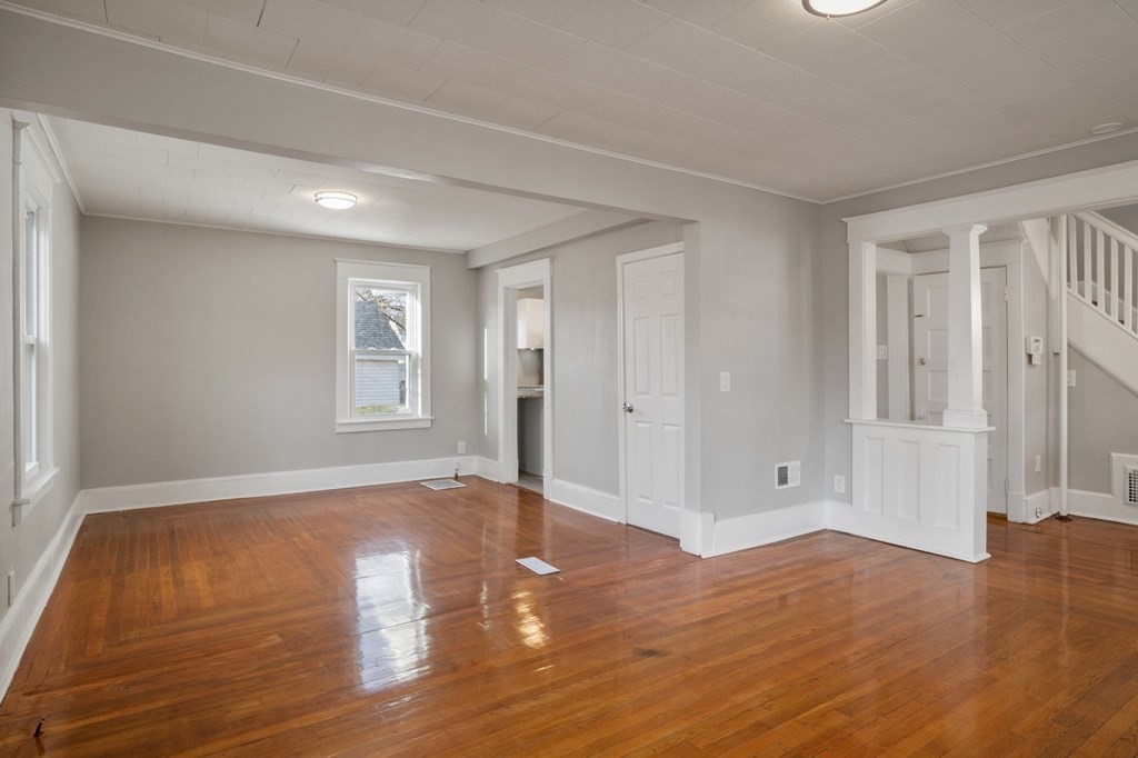 126 Stockman Street Springfield, MA 01104 - Photo 6 of 25 an empty room with wooden floor and windows