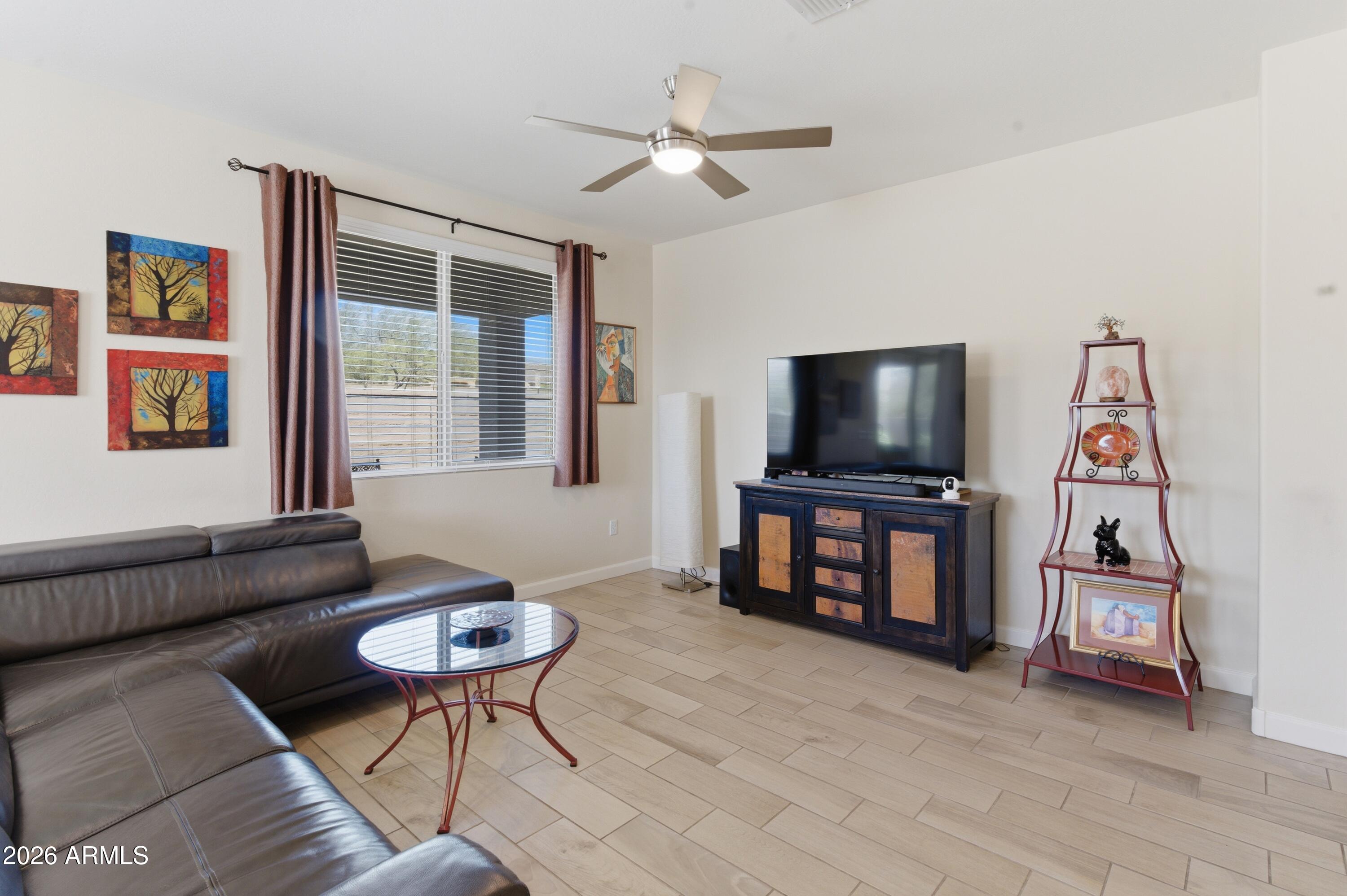 4654 North 204th Lane Buckeye, AZ 85396 - Photo 18 of 41 a living room with furniture and a flat screen tv