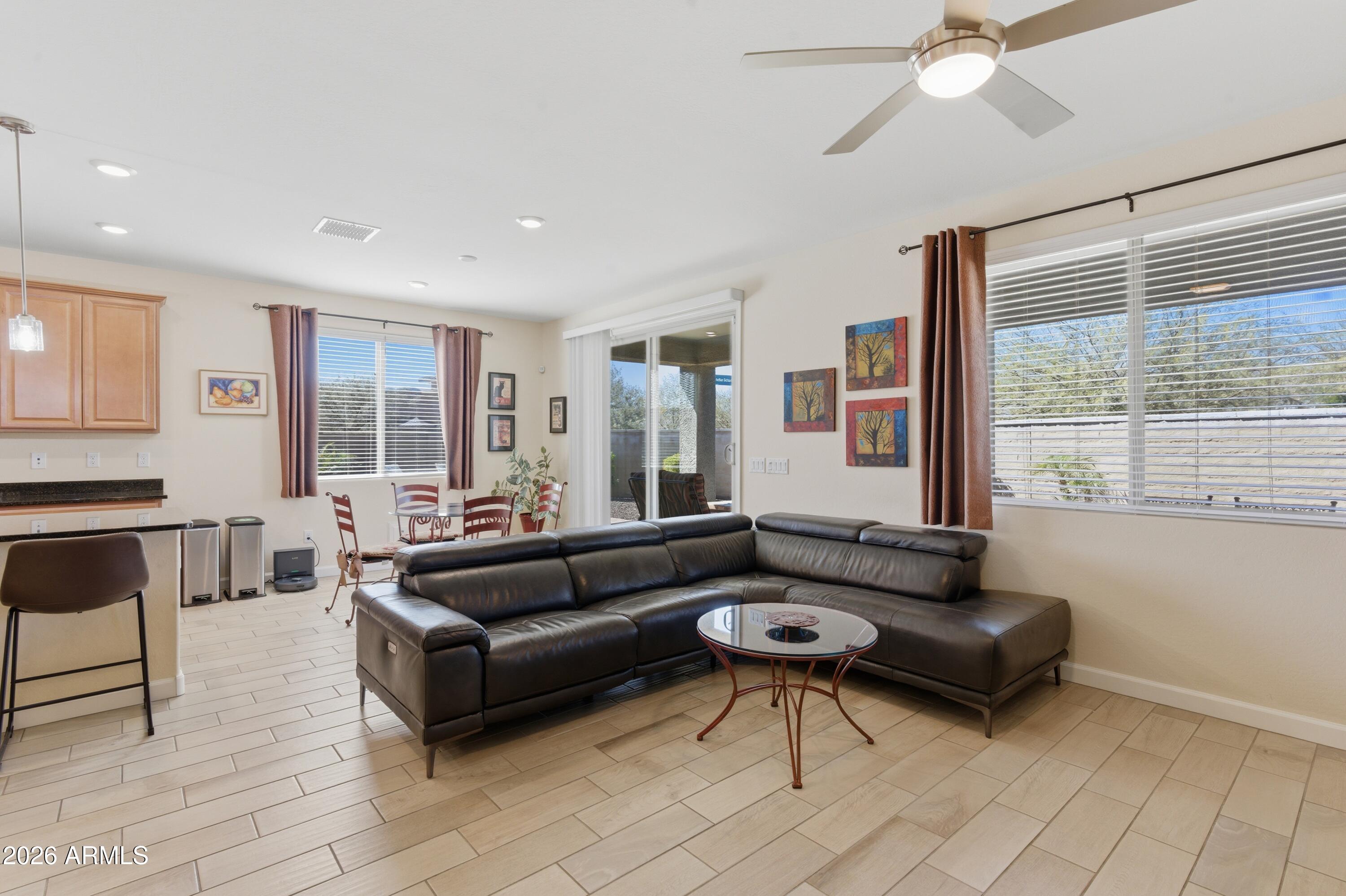 4654 North 204th Lane Buckeye, AZ 85396 - Photo 19 of 41 a living room with furniture and a large window