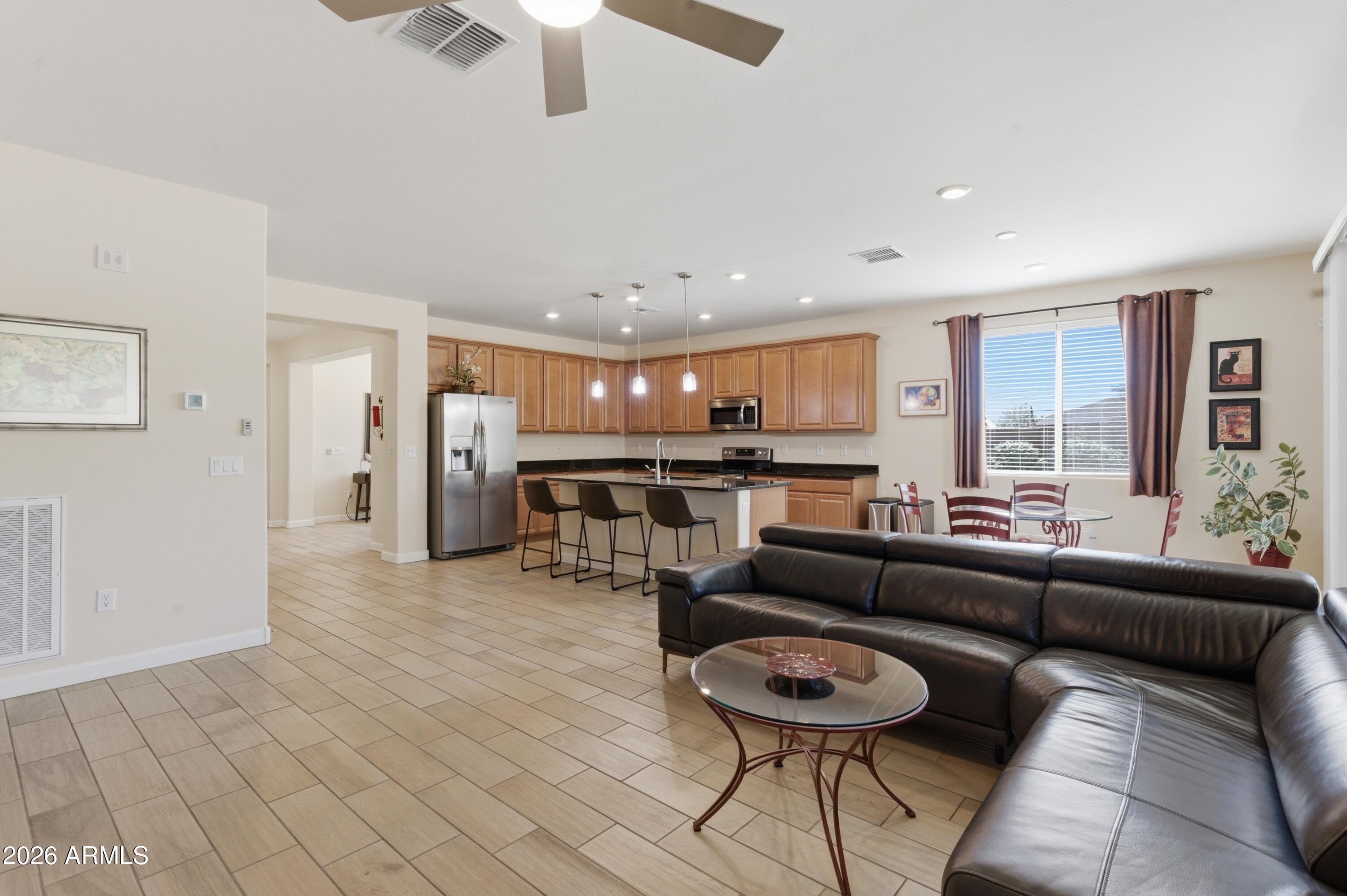 4654 North 204th Lane Buckeye, AZ 85396 - Photo 21 of 41 a living room with furniture and a large window