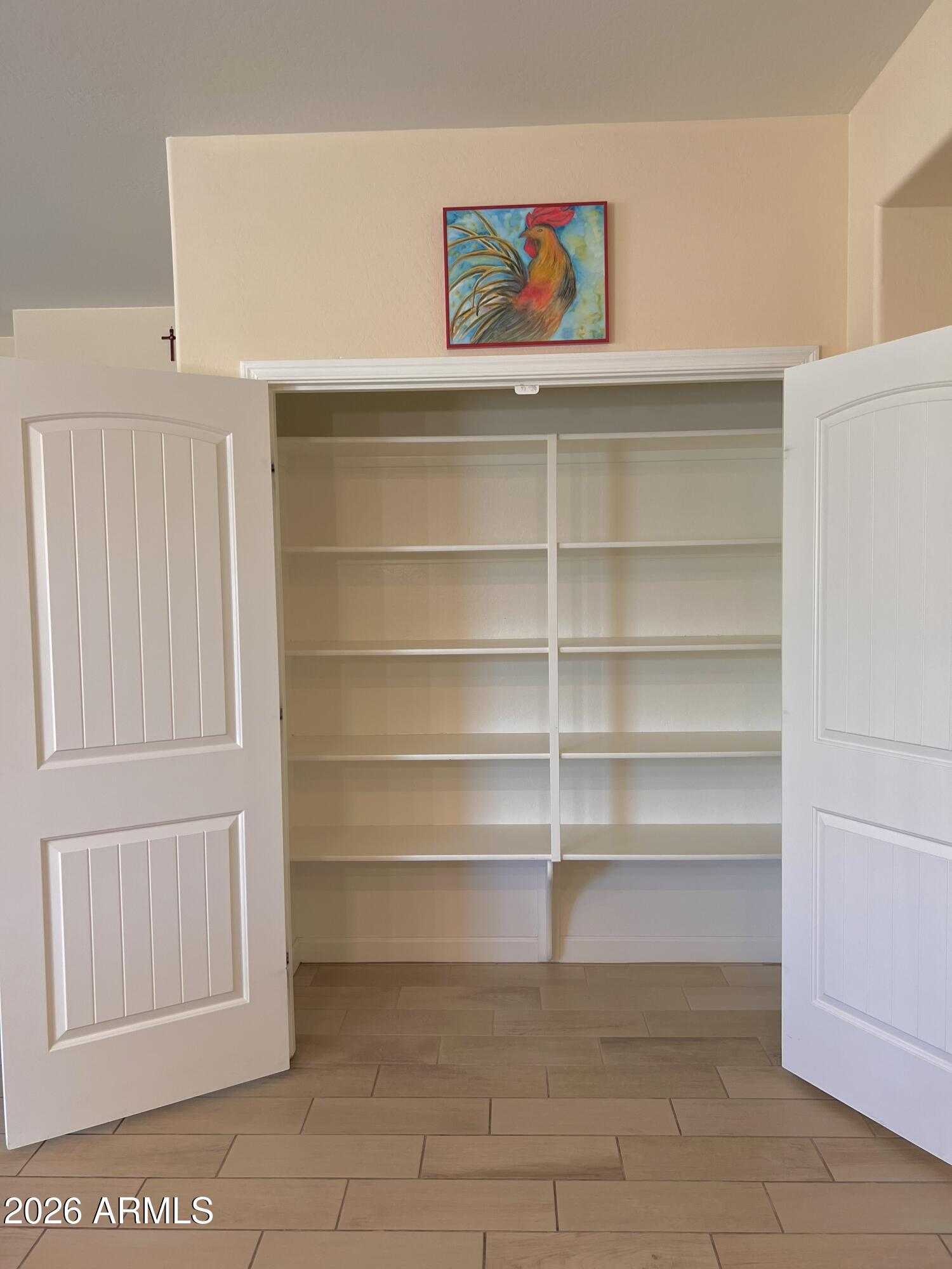 4654 North 204th Lane Buckeye, AZ 85396 - Photo 22 of 41 a view of a room with shelves