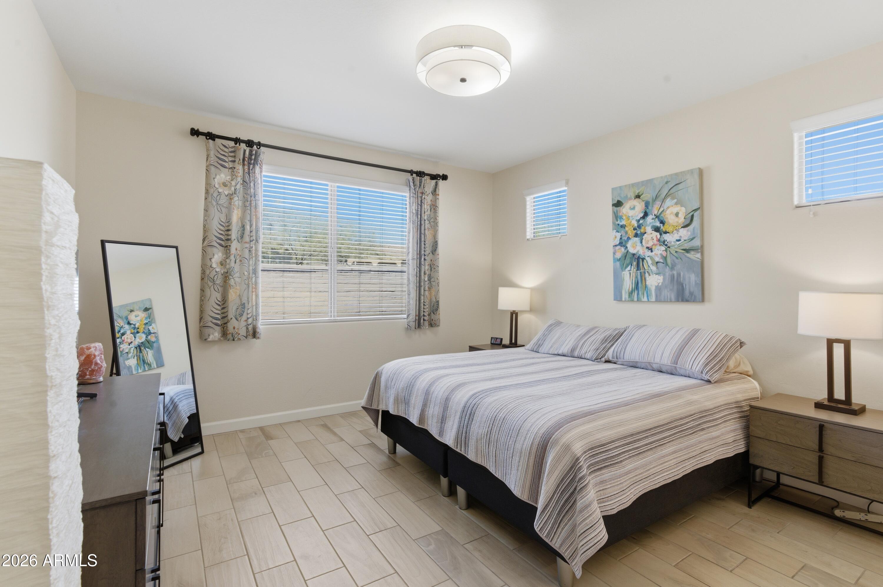 4654 North 204th Lane Buckeye, AZ 85396 - Photo 25 of 41 a bedroom with a bed and a window