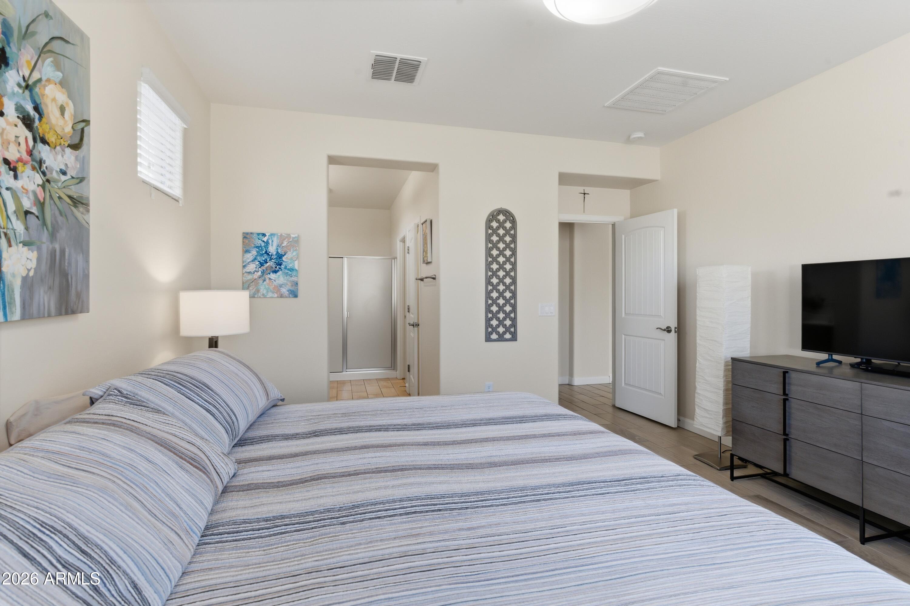 4654 North 204th Lane Buckeye, AZ 85396 - Photo 26 of 41 a bedroom with a bed and a flat screen tv