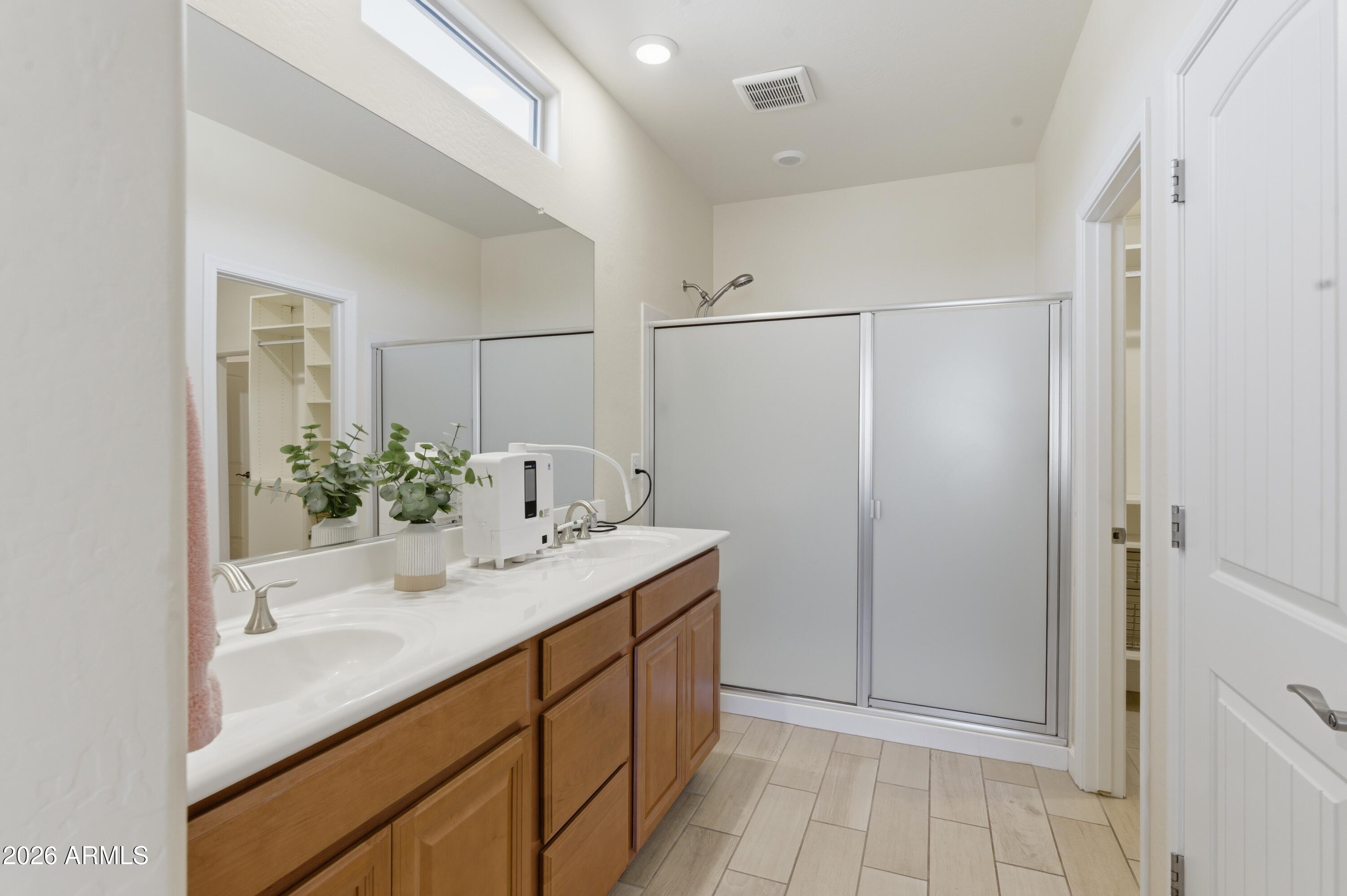 4654 North 204th Lane Buckeye, AZ 85396 - Photo 27 of 41 a bathroom with a sink and a mirror