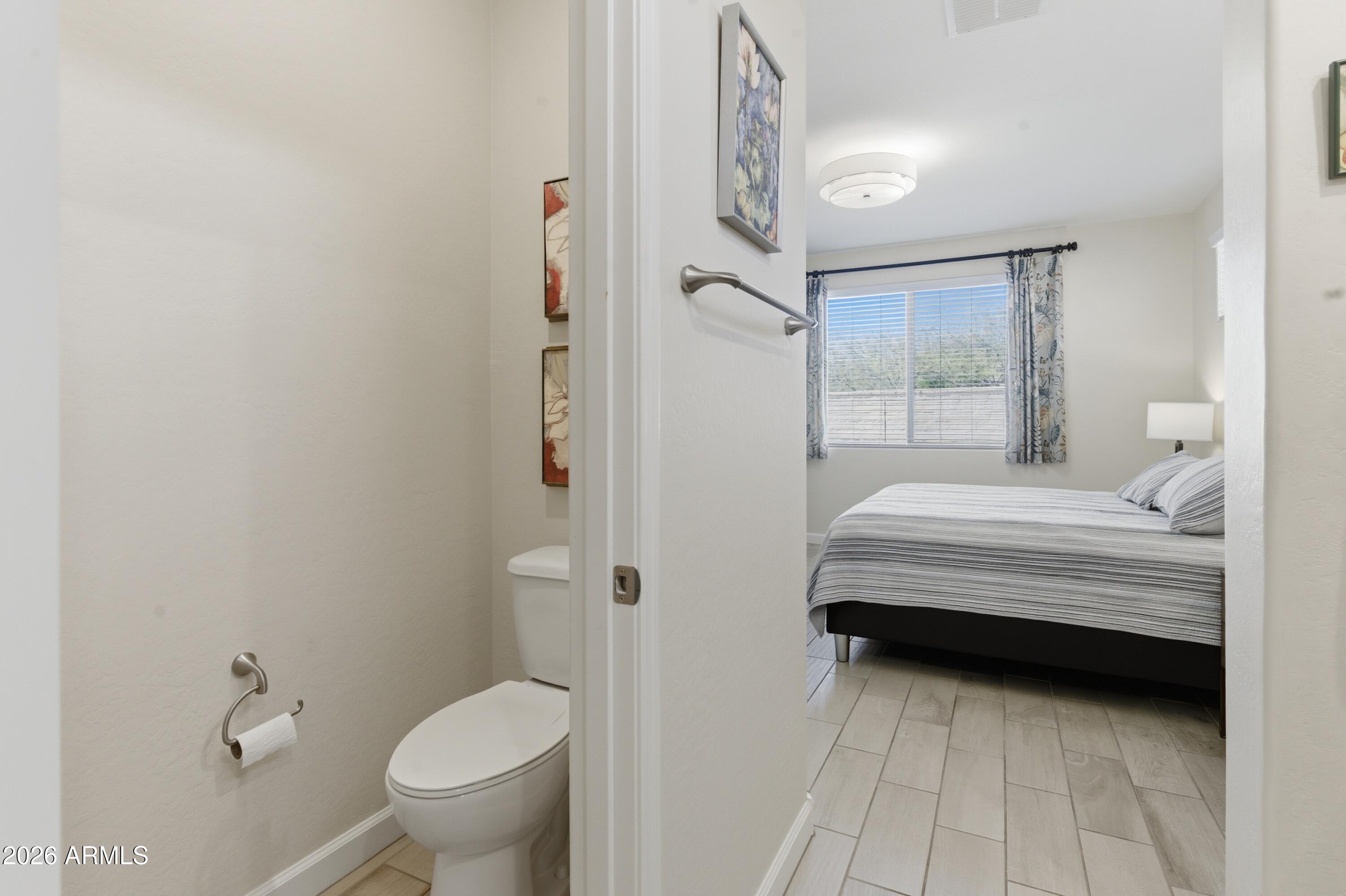 4654 North 204th Lane Buckeye, AZ 85396 - Photo 28 of 41 a bathroom with a toilet sink and shower