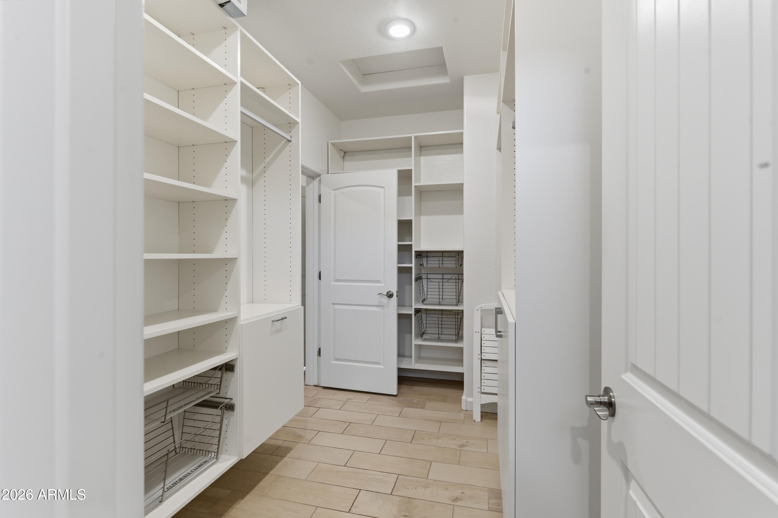 4654 North 204th Lane Buckeye, AZ 85396 - Photo 29 of 41 a view of walk in closet with empty racks