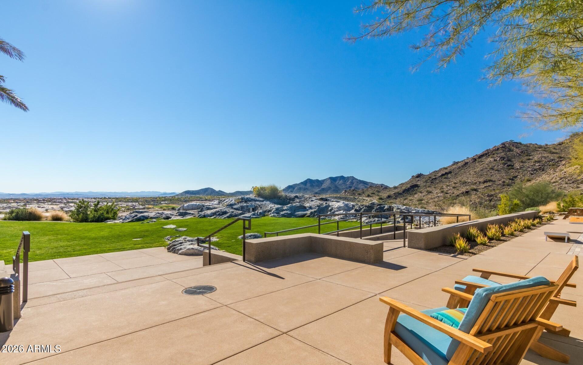 4654 North 204th Lane Buckeye, AZ 85396 - Photo 40 of 41 a view of a terrace with a table and chairs under an umbrella