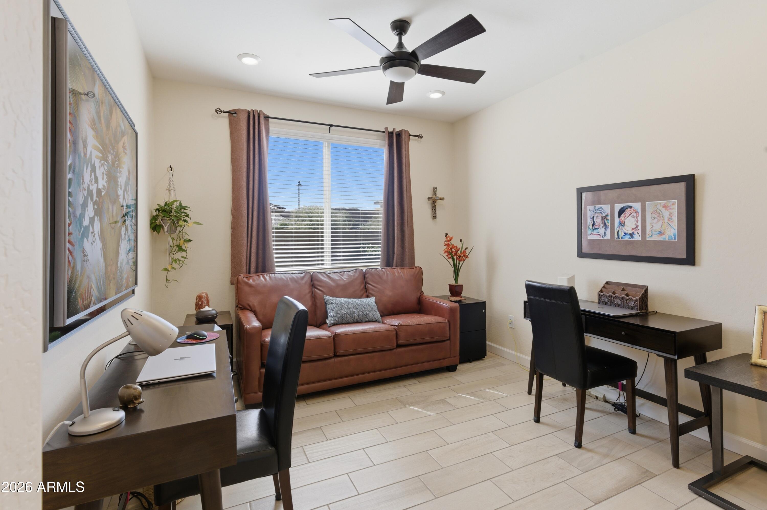 4654 North 204th Lane Buckeye, AZ 85396 - Photo 7 of 41 a living room with furniture and a window