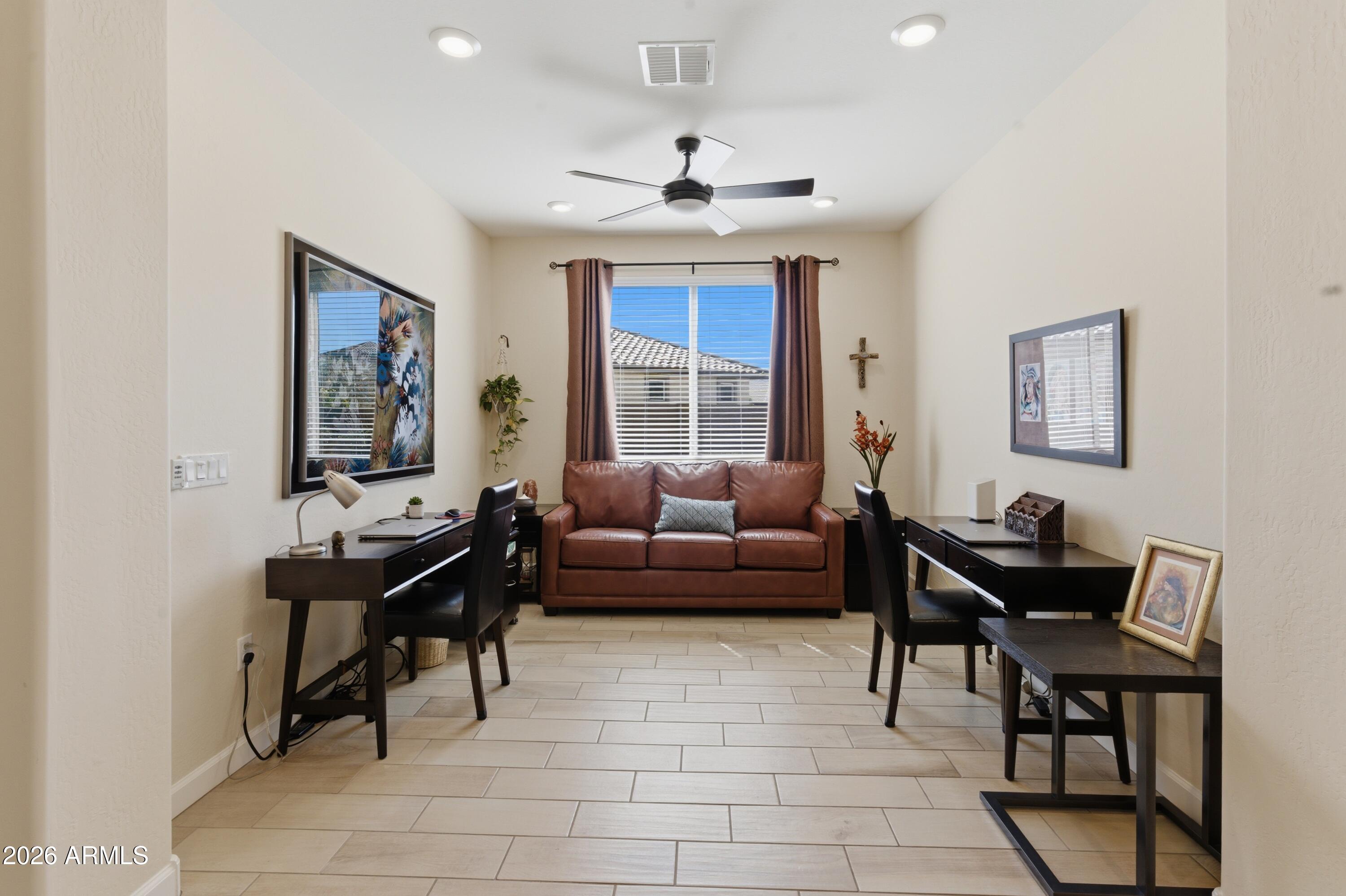 4654 North 204th Lane Buckeye, AZ 85396 - Photo 8 of 41 a living room with furniture and a window