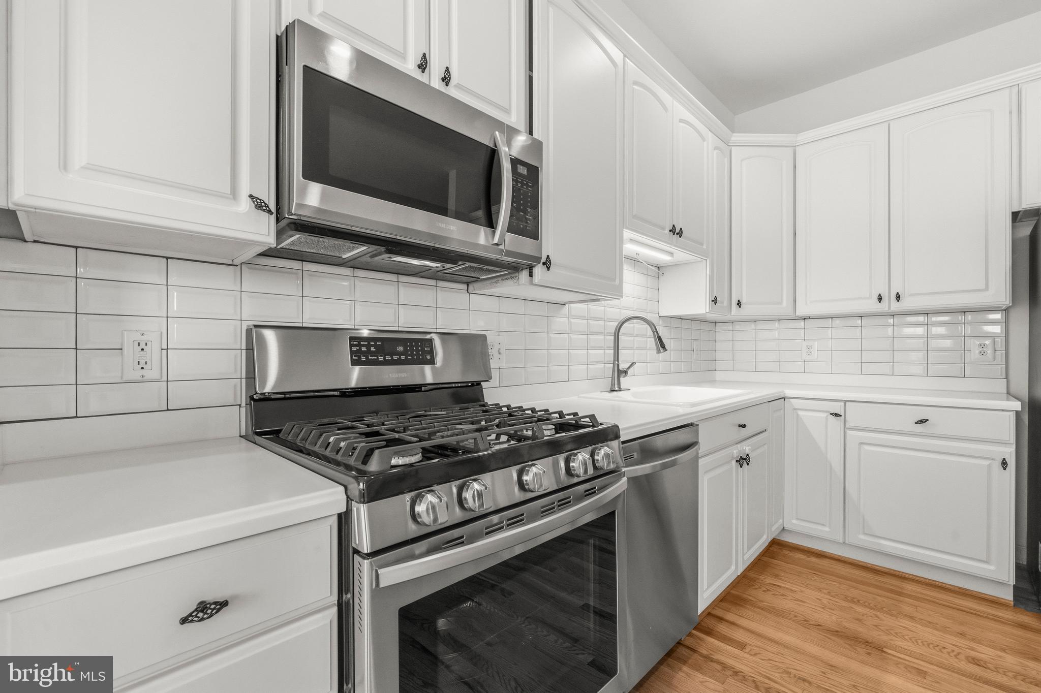 43003 Golf View Drive Chantilly, VA 20152 - Photo 11 of 54 a kitchen with stainless steel appliances granite countertop a stove and a microwave