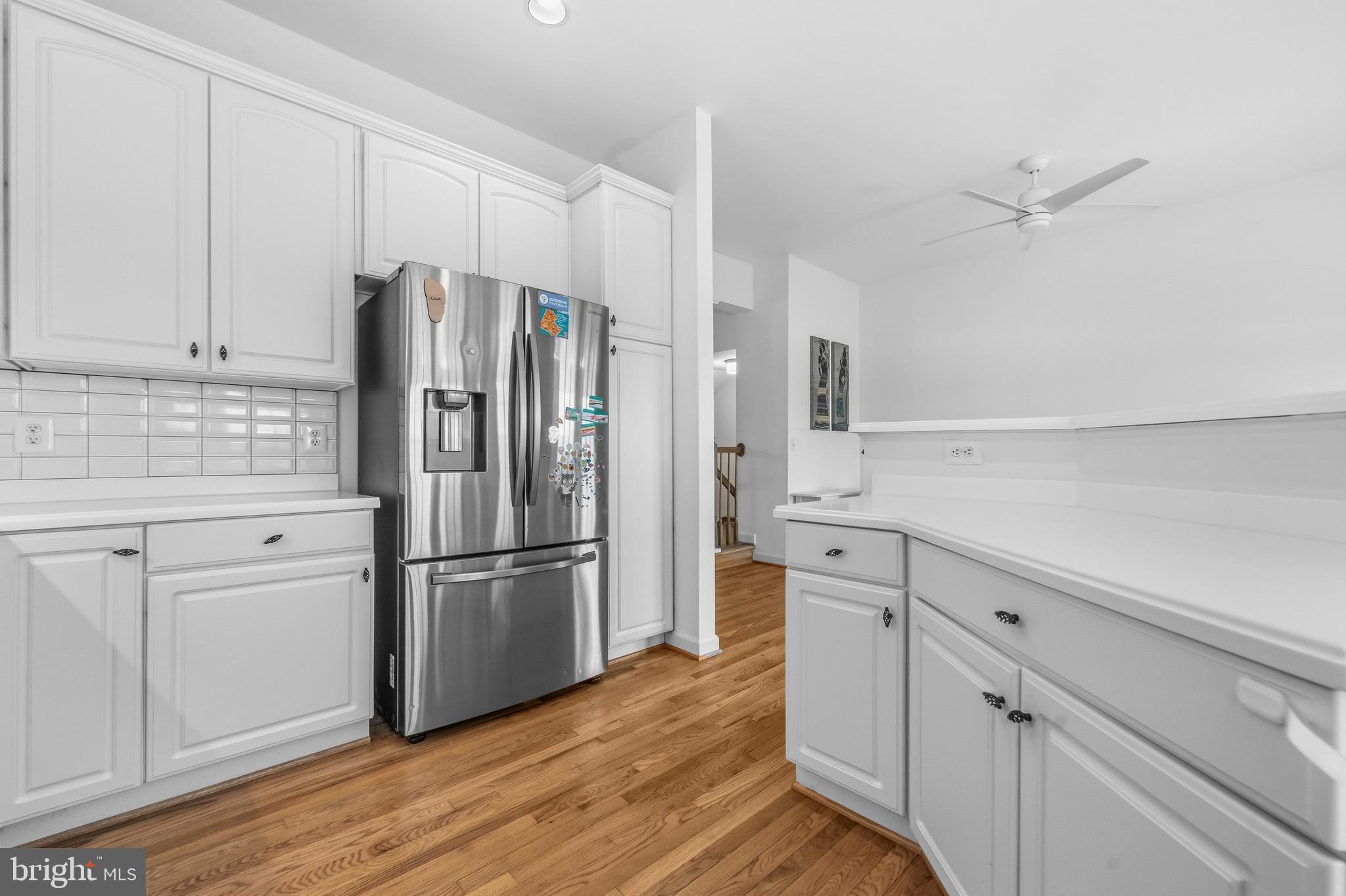 43003 Golf View Drive Chantilly, VA 20152 - Photo 12 of 54 a kitchen with white cabinets and stainless steel appliances