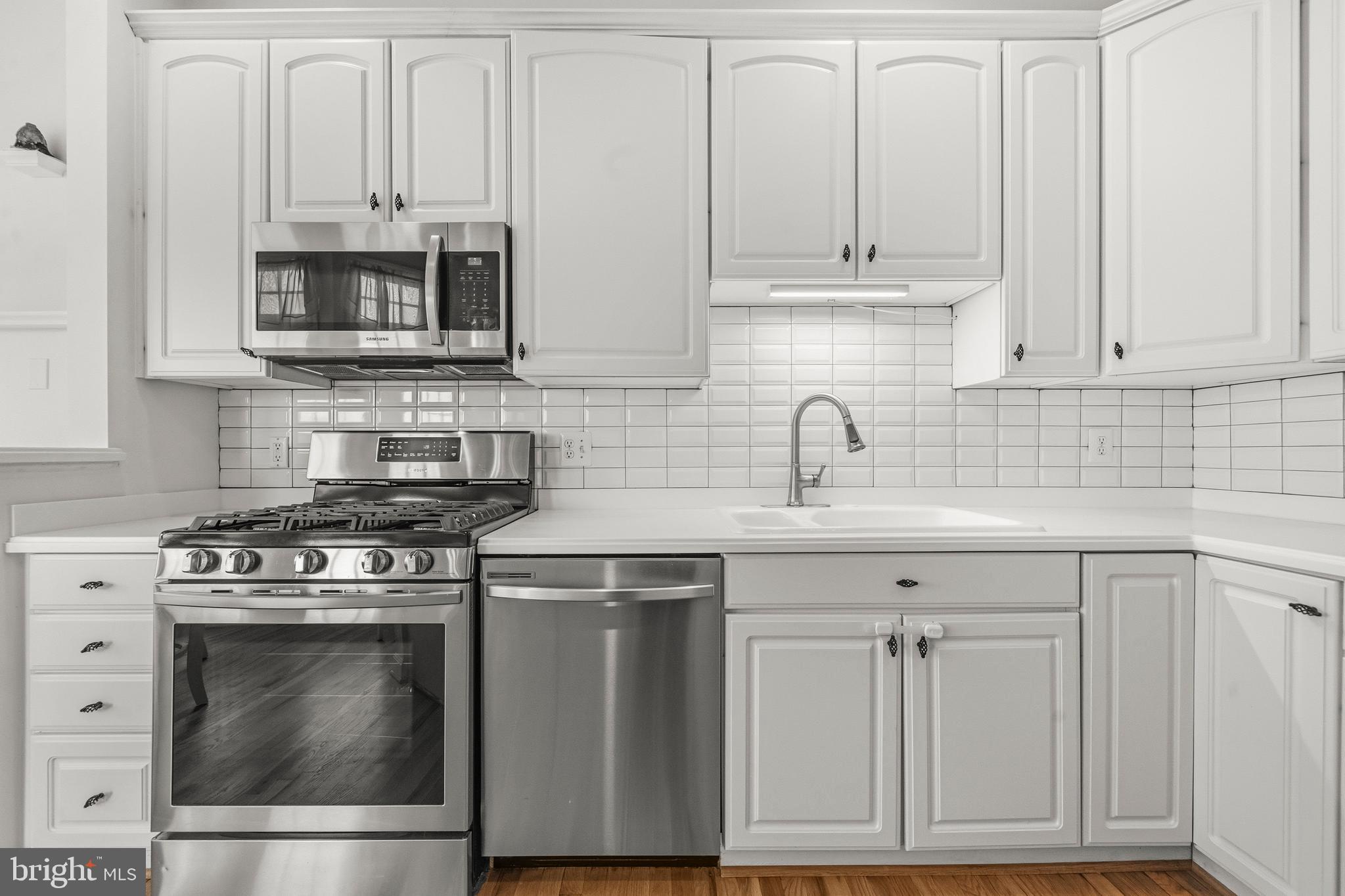 43003 Golf View Drive Chantilly, VA 20152 - Photo 12 of 54 a kitchen with stainless steel appliances granite countertop a stove a microwave and a sink