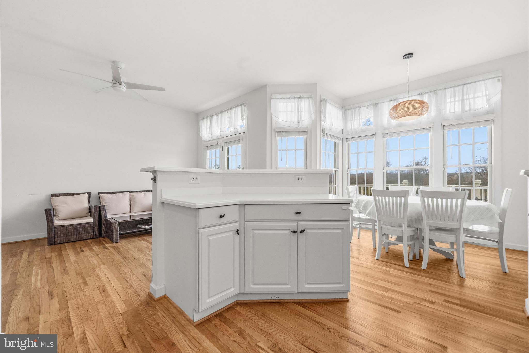 43003 Golf View Drive Chantilly, VA 20152 - Photo 14 of 54 a kitchen with kitchen island a dining table chairs and wooden floor