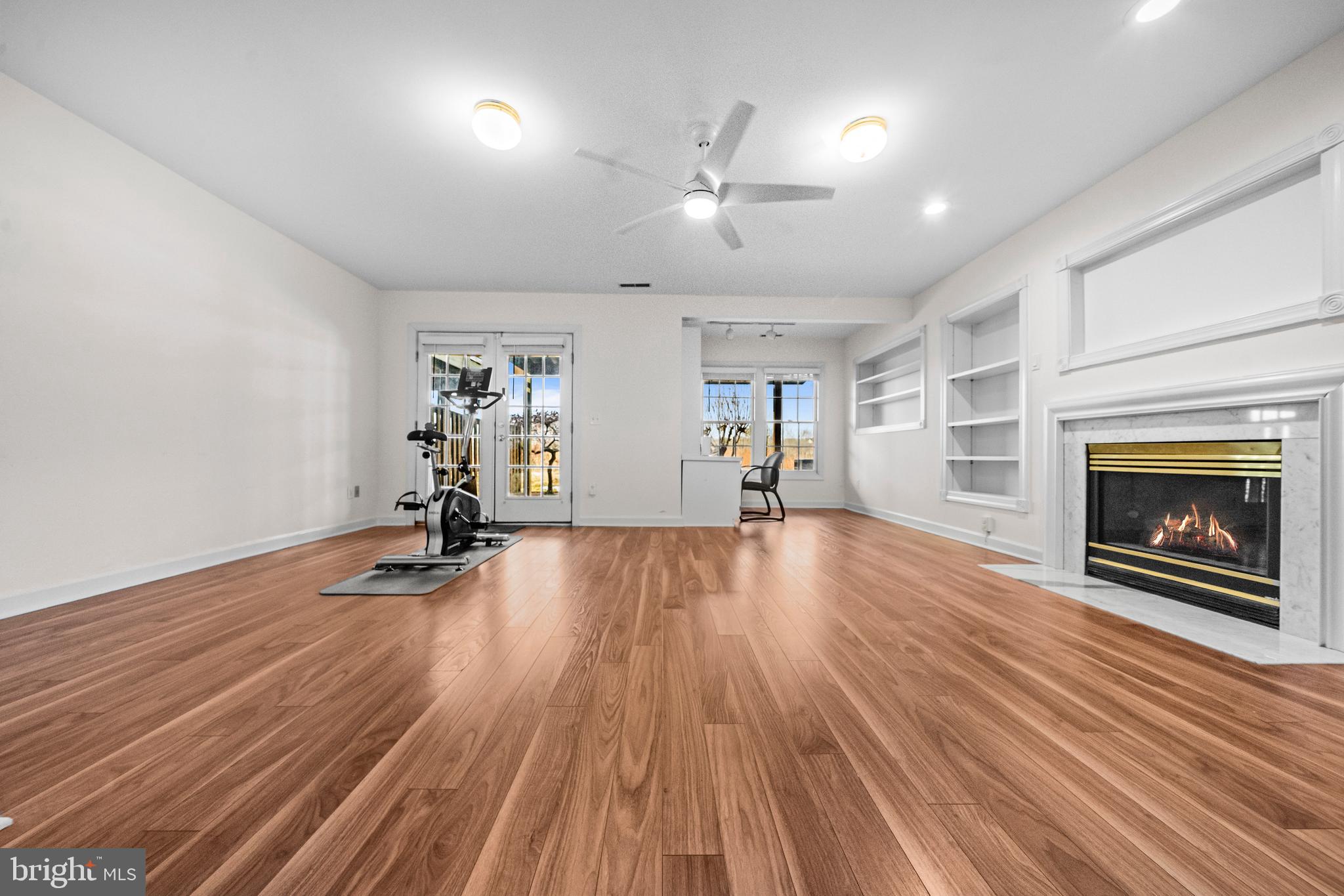 43003 Golf View Drive Chantilly, VA 20152 - Photo 33 of 54 an empty room with wooden floor fireplace and windows