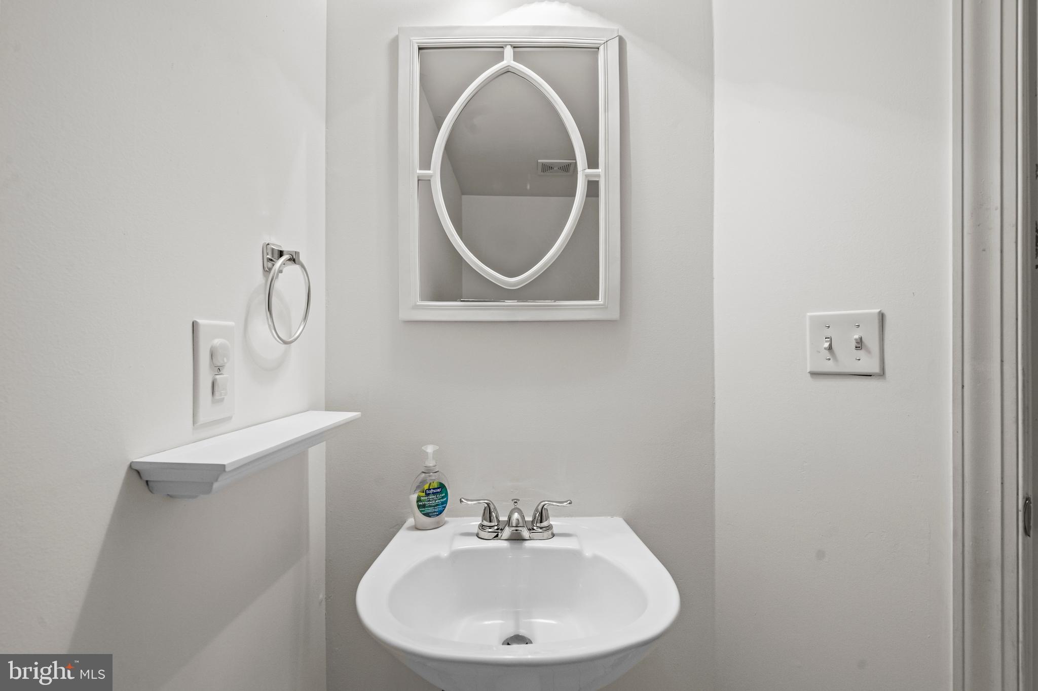 43003 Golf View Drive Chantilly, VA 20152 - Photo 39 of 54 a bathroom with a sink and a mirror