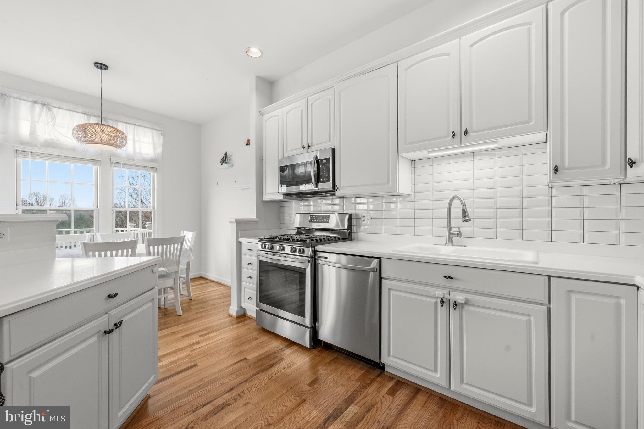 43003 Golf View Drive Chantilly, VA 20152 - Photo 9 of 54 a kitchen with white cabinets sink and stainless steel appliances