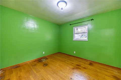 a view of a room with wooden floor and windows