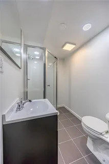 a yellow house with a big yard plants and large trees