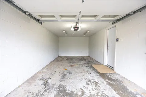 a white house that has a tree in front of it