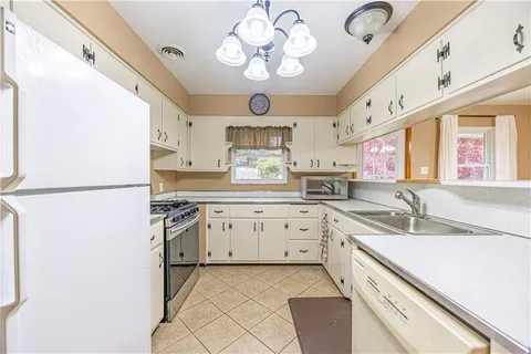 a kitchen with a sink stove and cabinets