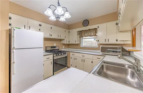 a kitchen with a refrigerator and a sink