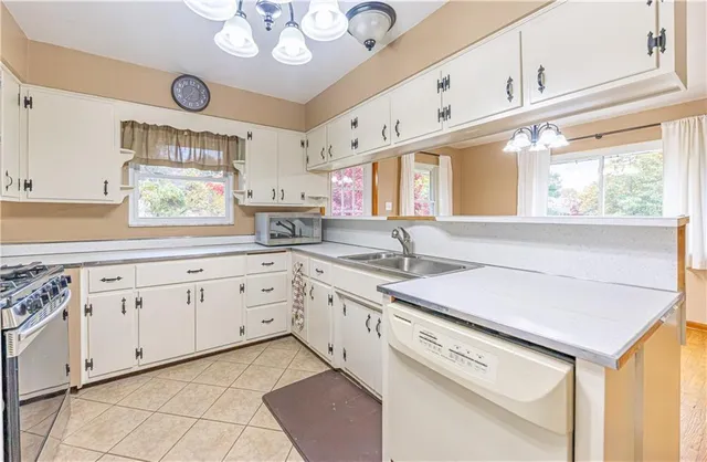 a kitchen with granite countertop cabinets a sink a window and stainless steel appliances