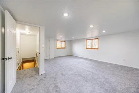 an empty room with a empty space and windows