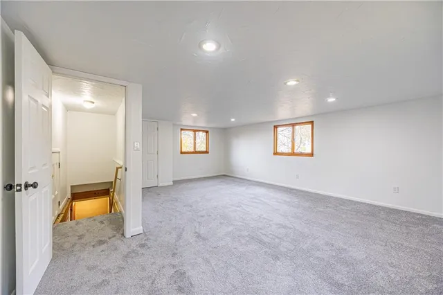 an empty room with a empty space and windows