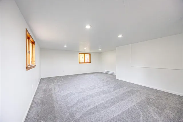 a big room with wooden floor and windows