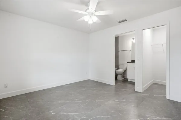 wooden floor in an empty room and a bathroom