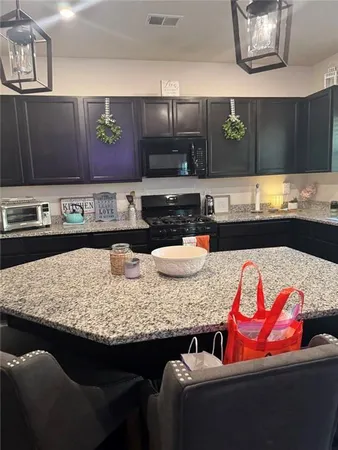 a kitchen with a sink and a stove top oven