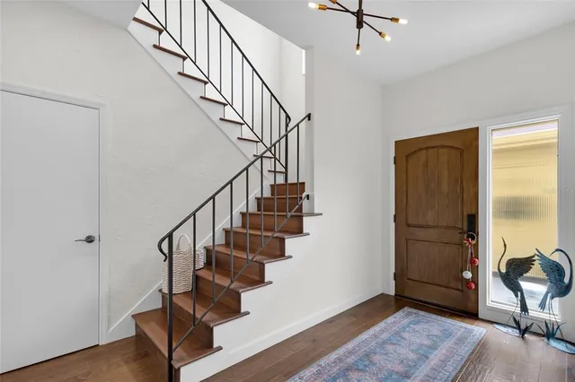 a living room with furniture a fireplace and a large window