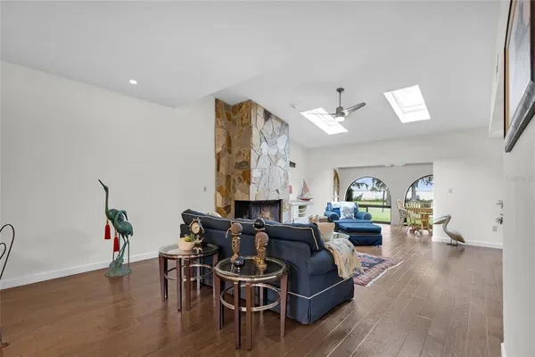 a living room with furniture and potted plants