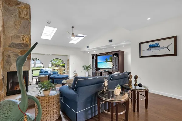 a living room with furniture a fireplace and a large window