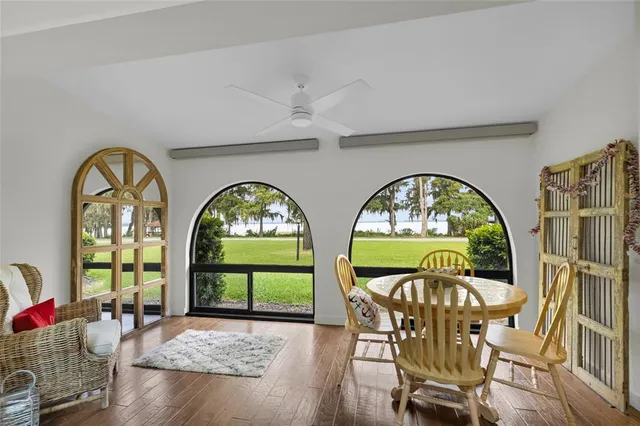 a kitchen with stainless steel appliances kitchen island granite countertop a table and chairs in it