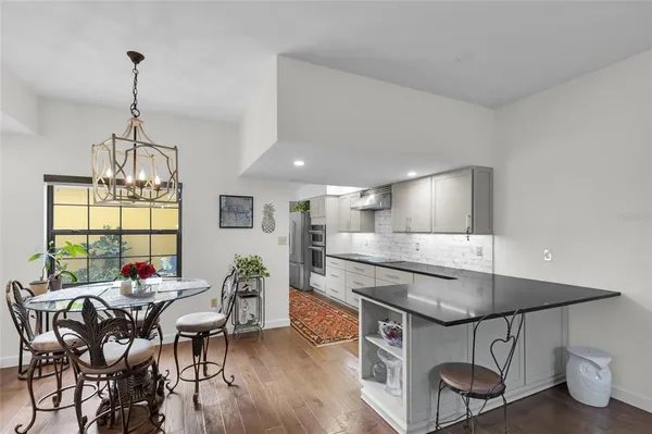 a kitchen with granite countertop a sink a stove and cabinets