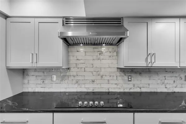 a view of staircase with wooden floor and white walls