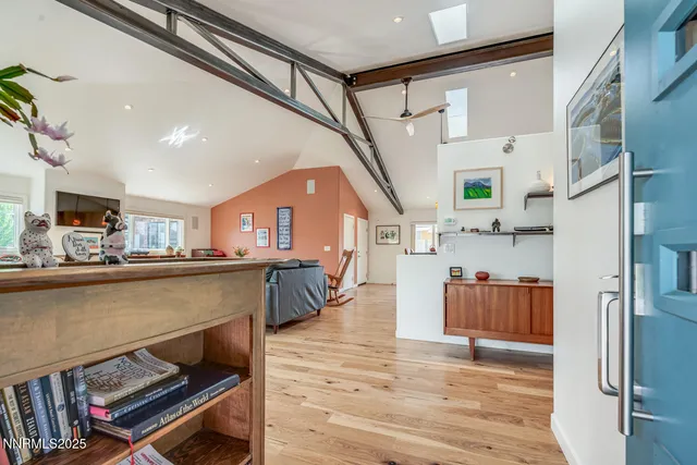 a view of a livingroom with furniture wooden floor and a window